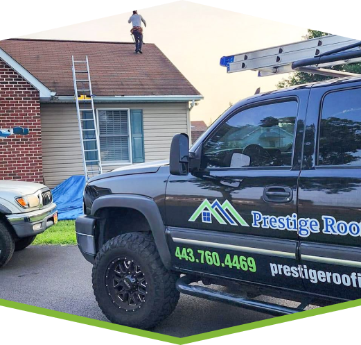 Contractor on a roof performing roof gutter tune up services